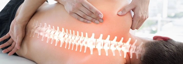 Person receiving a back massage with an overlay of the spine.