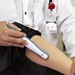 A healthcare professional applying cold laser therapy to a patient’s leg using a handheld device.